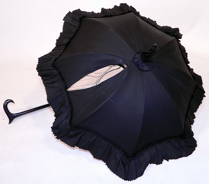 Victorian Civil War Black Silk Ebony Folding Handle Marquis Mourning Parasol
It is lined inside with black silk. The parasol measures 27 inches long extended, 16 inches long when folded and the fabric outside is 56 inches in circumference when opened up. 