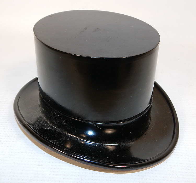 Vintage Paris Top Hat Box Never Used Mens Sock Garters & Suspenders Braces
There is a decorative black plastic top hat container which opens up to expose the inside contents, brown satin sock garters and brown, white striped suspenders braces, with gold metal hardware and stamped "Paris" brand. 
