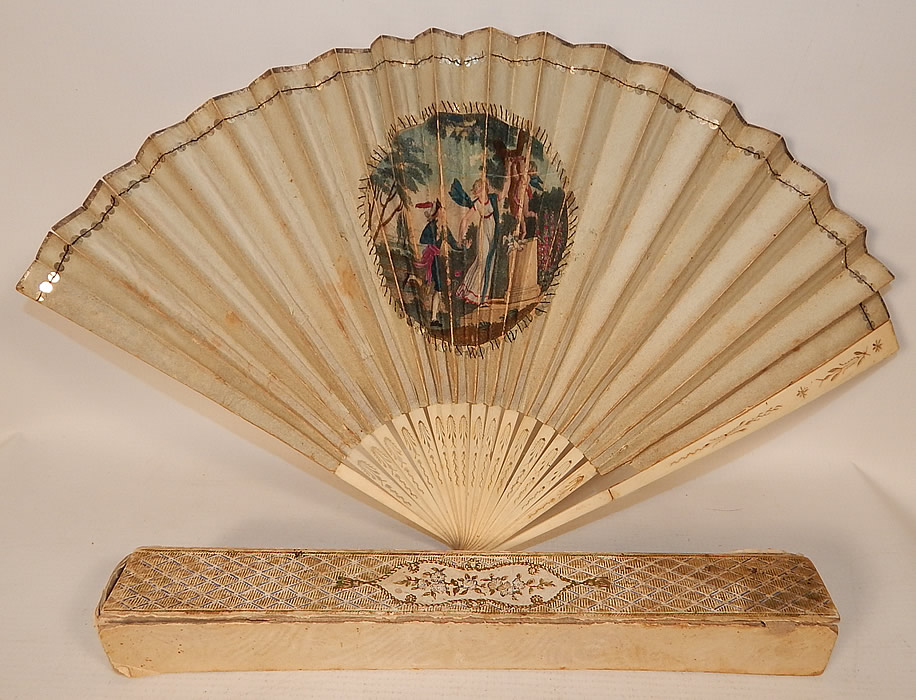 Antique 18th Century Hand Painted Paper Sequin Pierced Carved Folding Fan & Box
This antique 18th century hand painted paper sequin pierced carved folding fan and box dates from the late 1700s. It is made of pleated paper with a hand painted vignette medallion on the front, hand stitched gold metal sequins and gold foil trim edging along the top. 