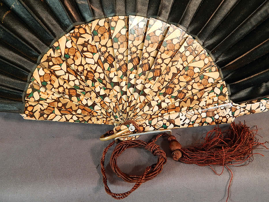 Victorian Black Silk Hand Painted Magnolia Chickadee Birds Decoupage Folding Fan
This fabulous fan has a unique mosaic style wood grain decoupage wooden sticks and guards, with a gold brass loop ring, mother of pearl rivet holding the fan together and a brown silk tassel, finger loop hanging down from the bottom. 